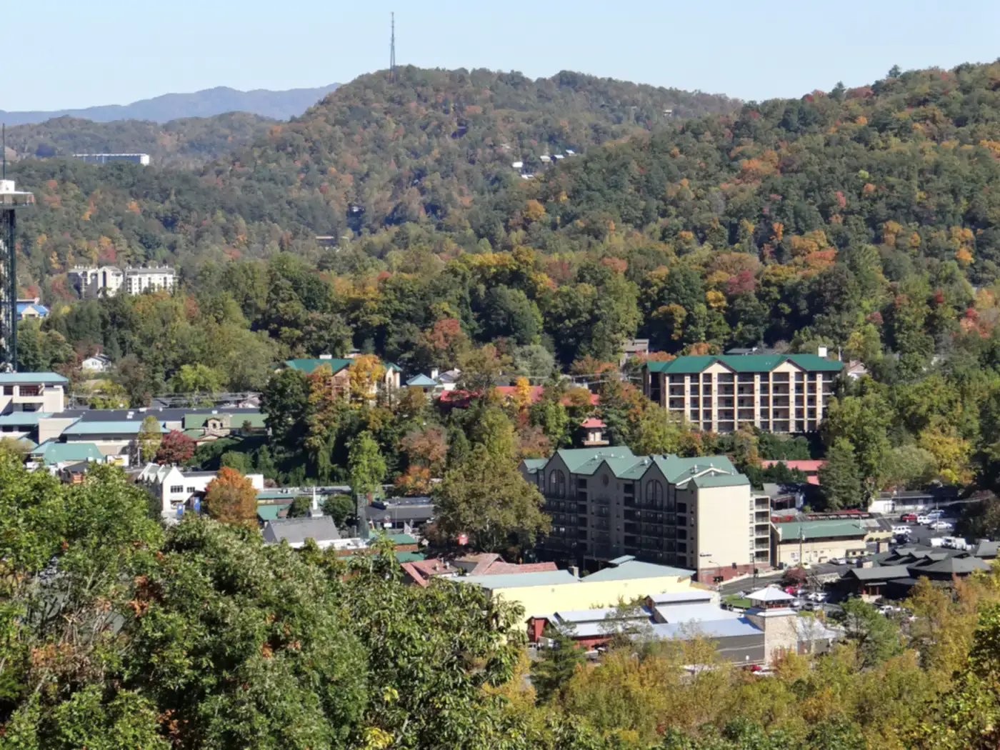 Small mountain town in a wooded valley with autumn color on the hills