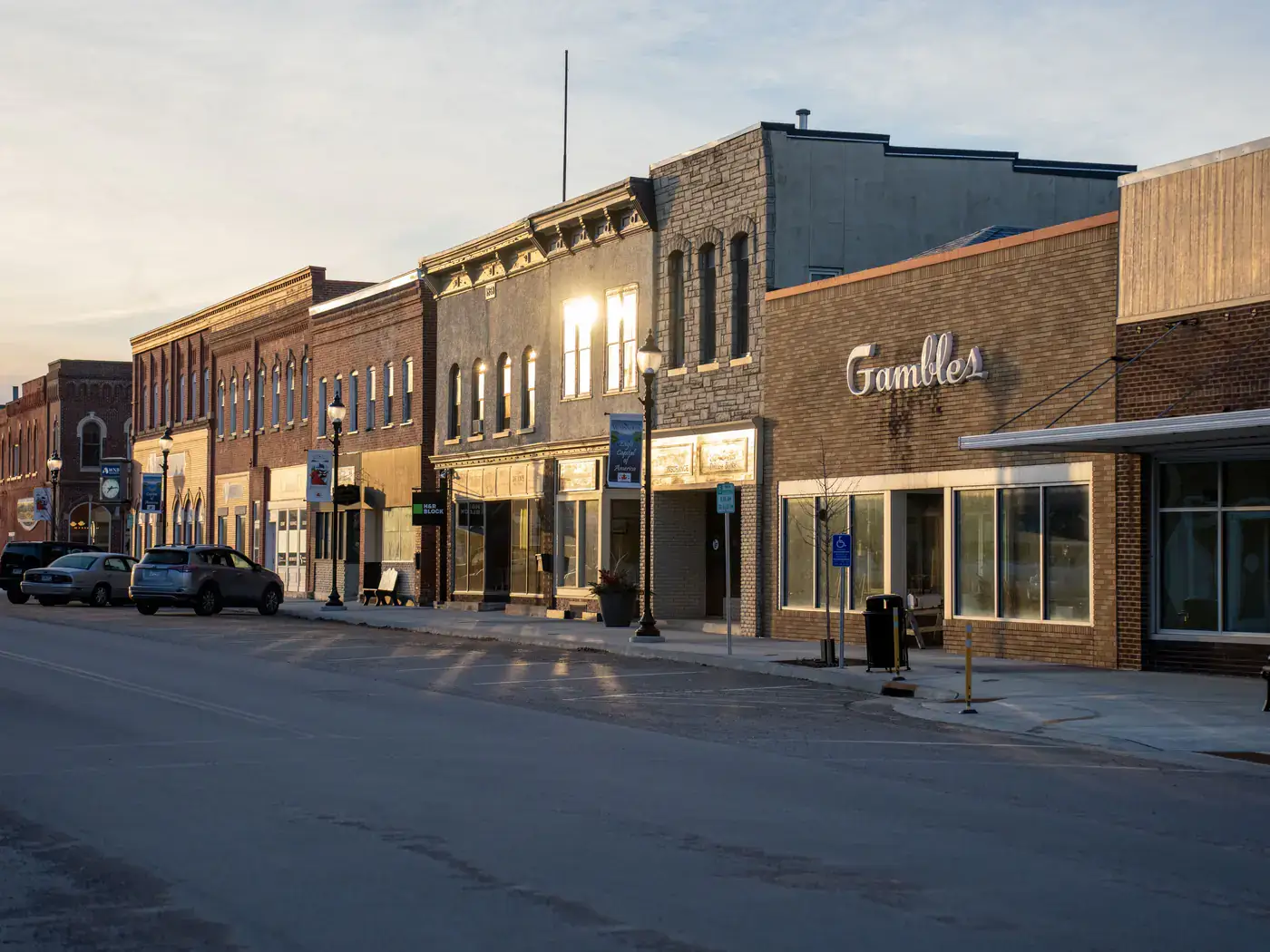 Main street lined with brick storefronts in early morning light