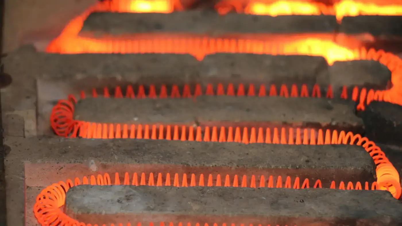 Coiled electric heating elements glowing bright orange