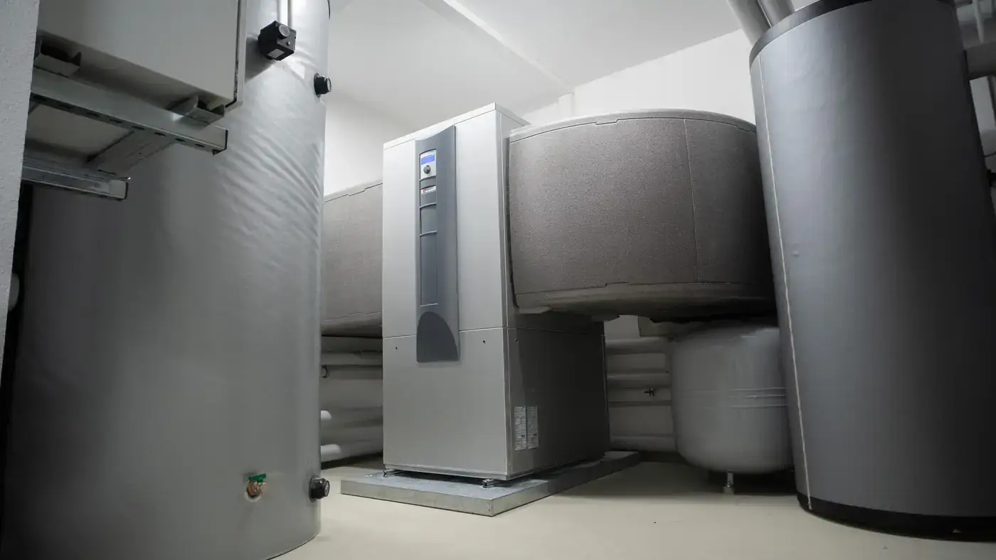 New heat pump unit and insulated storage tanks in a clean mechanical room