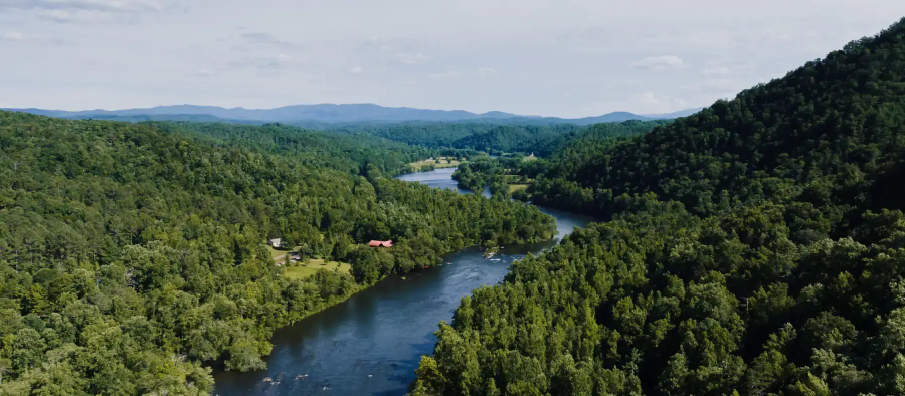 River winding through a steep wooded valley