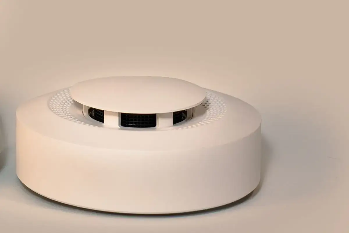 Close-up of a round white smoke detector