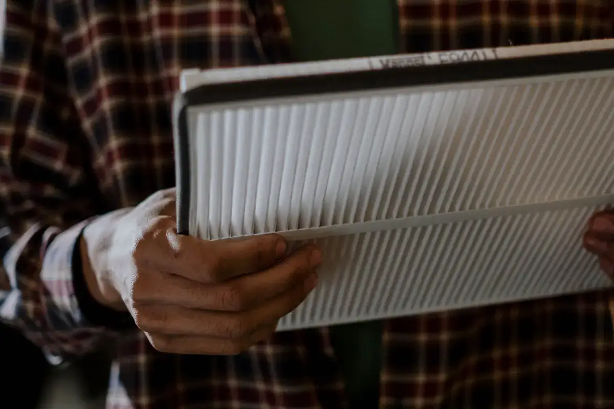 Hands holding a pleated panel air filter